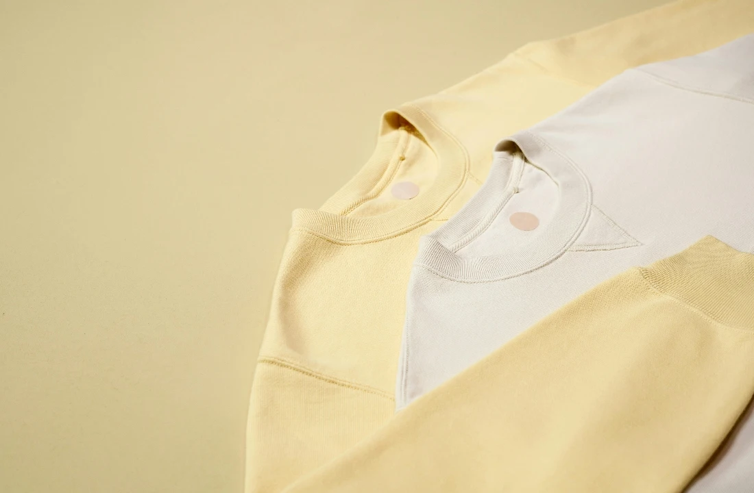 Boxy fit shirt neckline image showing a white crew neck shirt, suitable for discussing ribbing, collar recovery, neck tape, and oversized tee structure