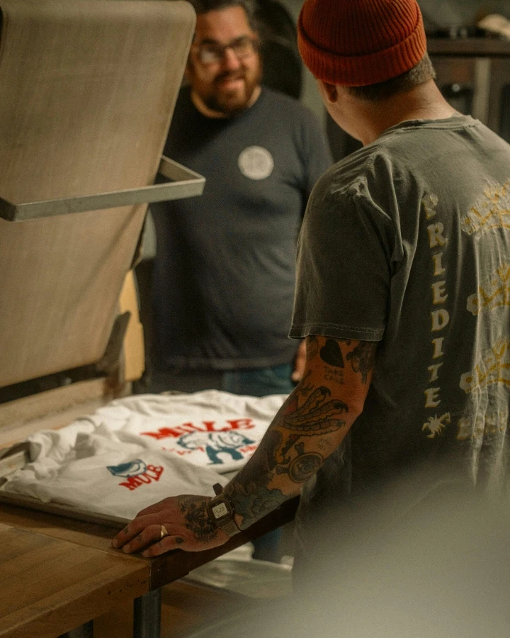 Custom apparel printing machine in a workshop, suitable for comparing DTG printing, DTF printing, screen printing, and order-volume decisions