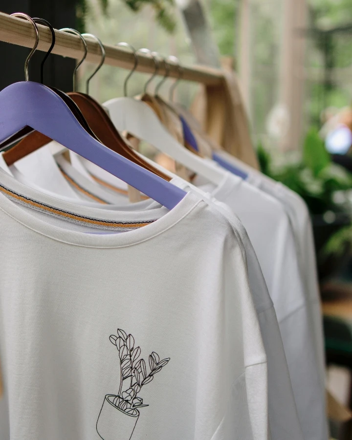 Custom T shirt design image showing a printed shirt on a retail rack, suitable for discussing graphic placement, artwork sizing, and pre-production layout checks
