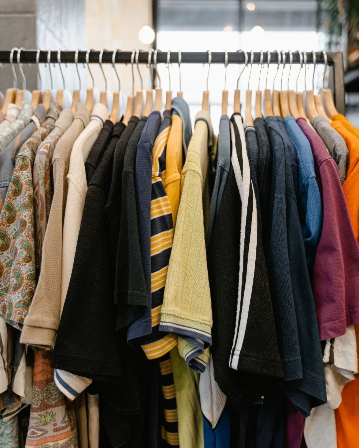Clothing rack with assorted shirts and apparel styles, suitable for planning pride apparel product mix and inclusive campaign collections