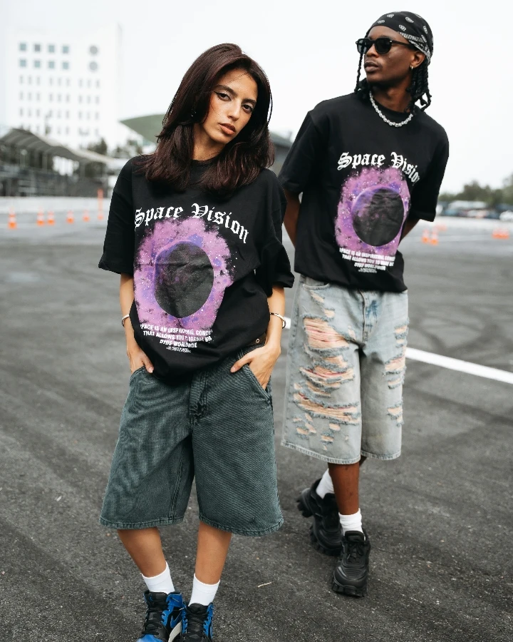 Two models wearing matching oversized graphic T-shirts, suitable for gender neutral apparel, unisex clothes, and custom pride shirts styling