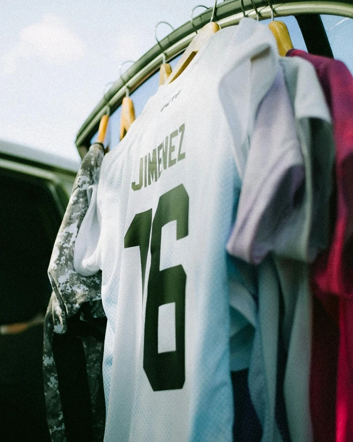 Football-style jersey hanging on a clothing rack, suitable for world cup shirts, custom football shirts, and fan apparel product category planning