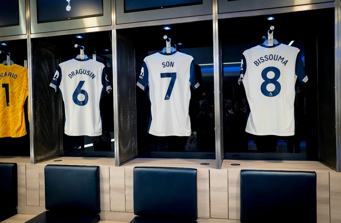 Custom Football Jerseys reference image showing official-style jerseys in a locker room, suitable for discussing IP risk, protected team assets, player names, and replica design boundaries