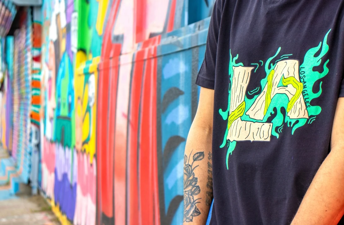 Print on Demand Streetwear close-up showing a black graphic T shirt with bold front artwork, suitable for custom streetwear apparel and POD design ideas