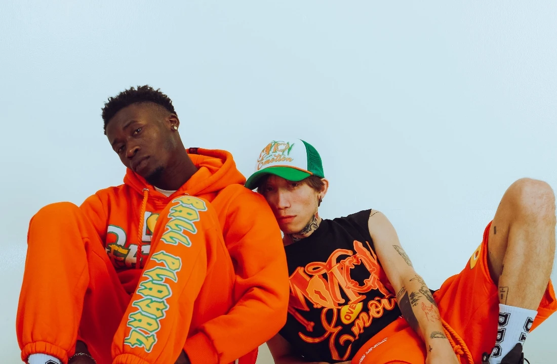 Print on Demand Streetwear image showing models wearing bold orange graphic streetwear pieces, suitable for custom hoodie and T shirt collection concepts