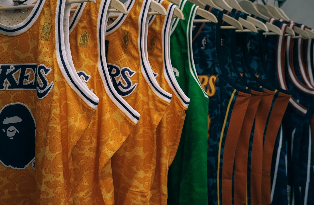 Fan Club Shirts image showing basketball-style jerseys displayed on a retail rack, suitable for basketball fan apparel, custom sports jerseys, and team merchandise planning