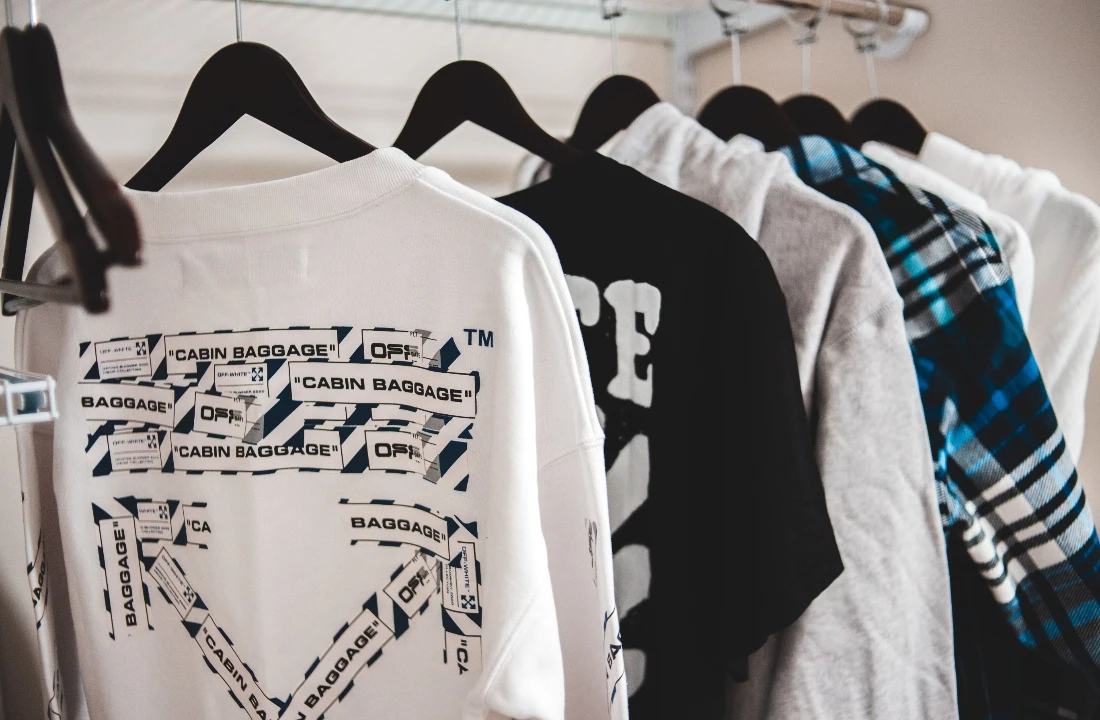 Print on Demand Streetwear image showing graphic sweatshirts and streetwear pieces on a clothing rack, suitable for POD product selection, custom apparel collections, and online streetwear merchandising