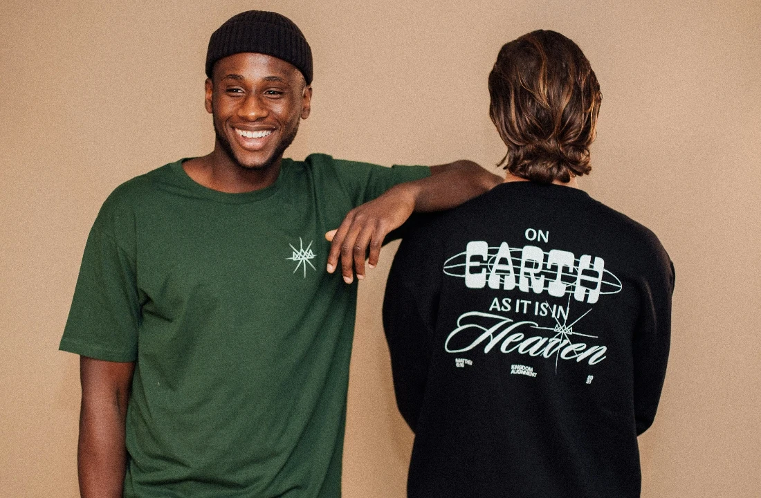 Two models presenting green and black Print on Demand Streetwear pieces with minimalist front branding and a large back graphic