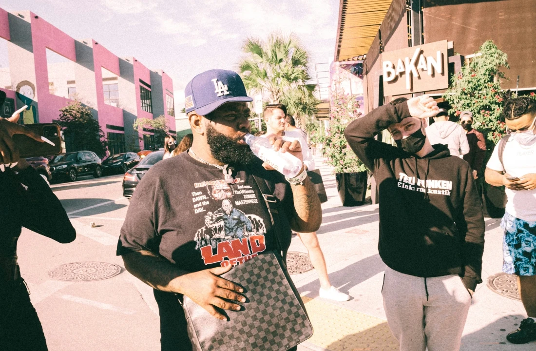 People wearing graphic T-shirts and hoodies in an outdoor urban setting, showing Print on Demand Streetwear styling for casual brand collections