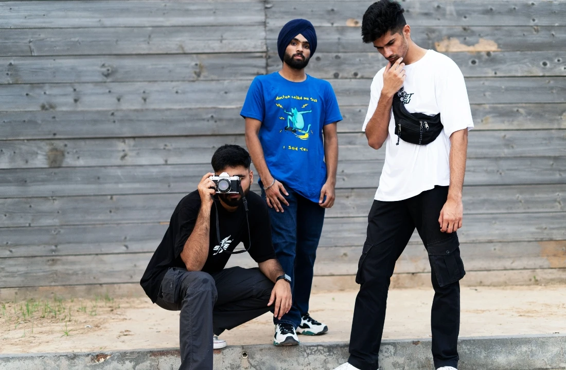 Three men wearing casual graphic T-shirts during an outdoor POD Streetwear fashion photoshoot