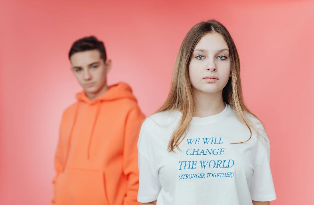 Young woman in a white Organic Cotton Custom T Shirts design with slogan print, styled with a casual fashion look
