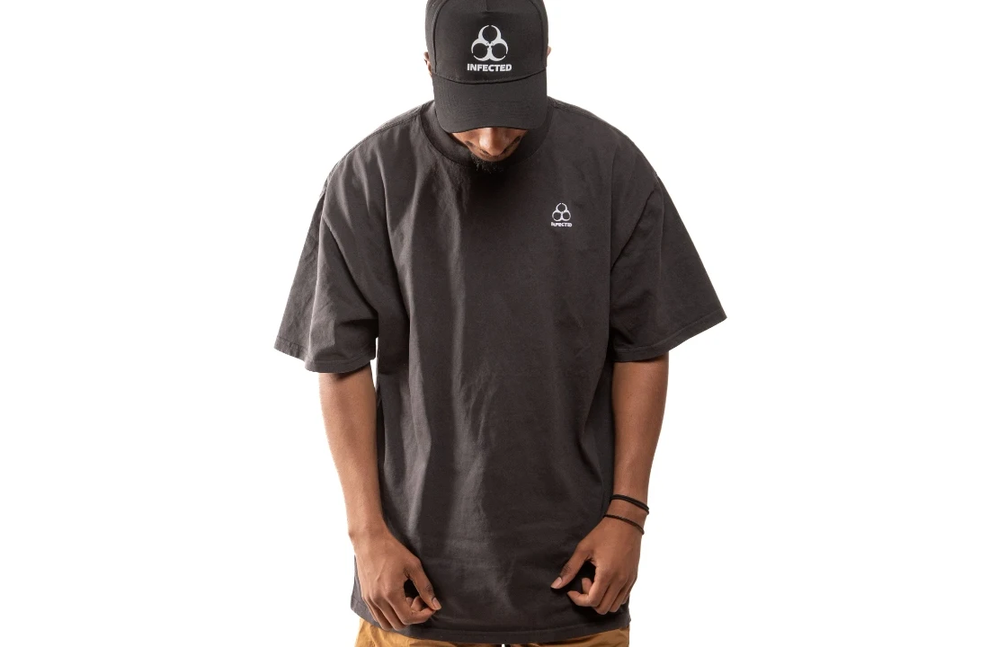 Model wearing an oversized black Organic Cotton Custom T Shirts blank with a relaxed streetwear fit