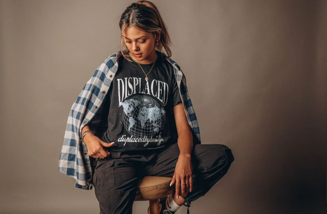 Woman styling washed t shirts with a plaid shirt and cargo pants for a casual streetwear outfit