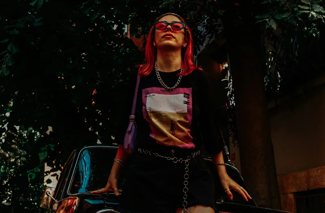 Person wearing a red hooded streetwear jacket surrounded by red smoke for dramatic Grunge Streetwear styling