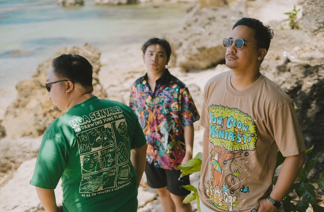 Group wearing colorful POD T shirts with illustrated graphics in a beach lifestyle scene