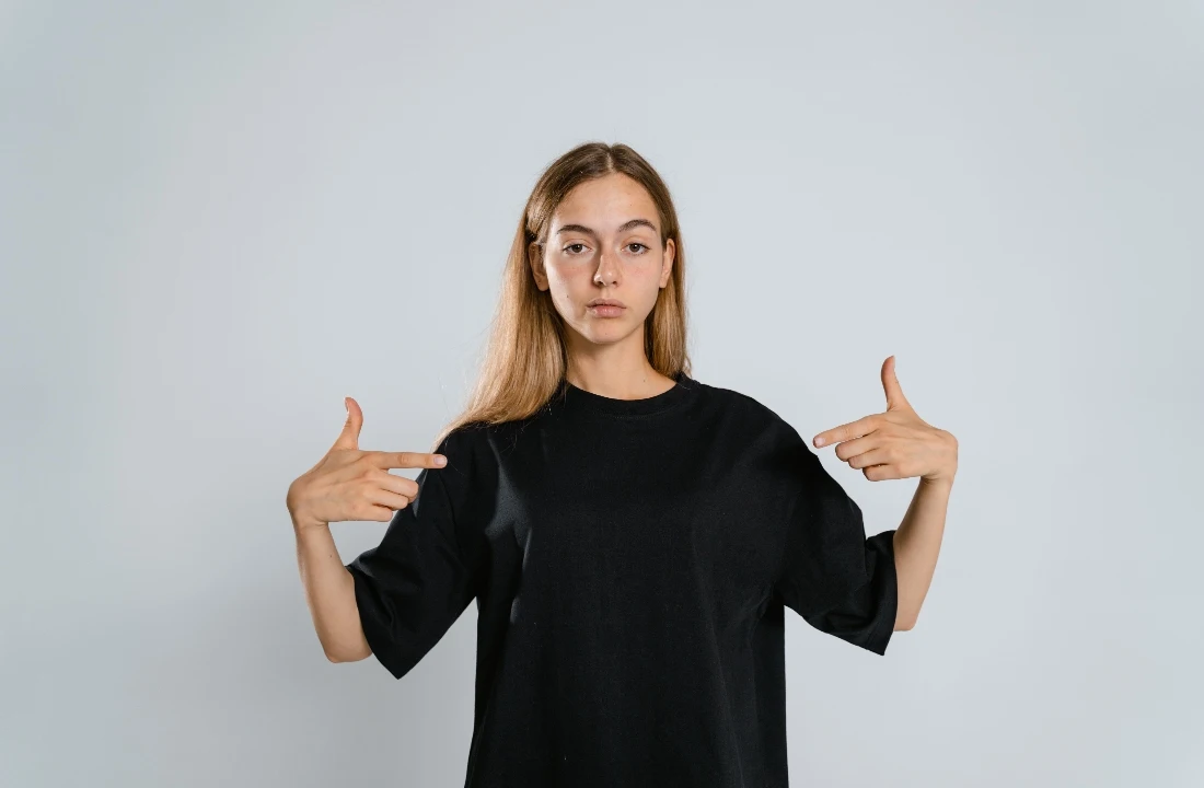 Model wearing a black best t shirt blanks sample with oversized fit against a clean studio background