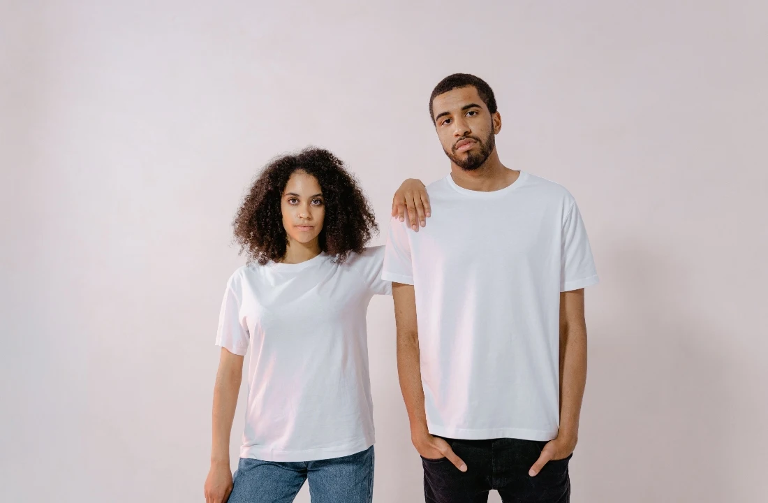Two models wearing white best t shirt blanks for unisex fit and sizing reference