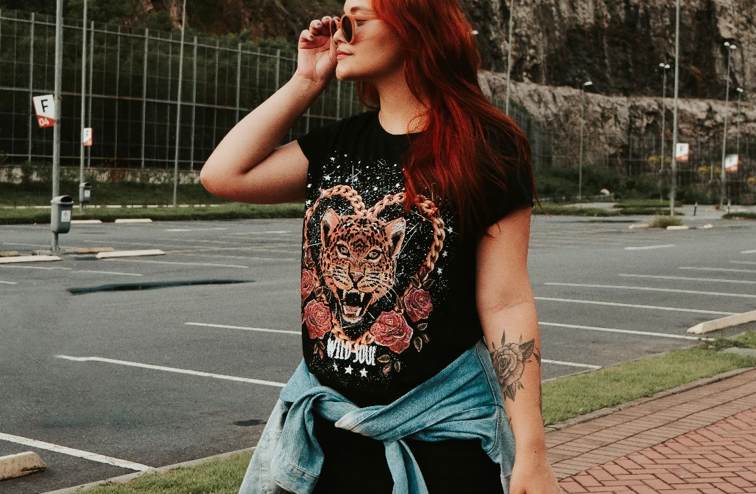 Woman wearing Custom Graphic Tees with a tiger graphic print in an outdoor streetwear setting