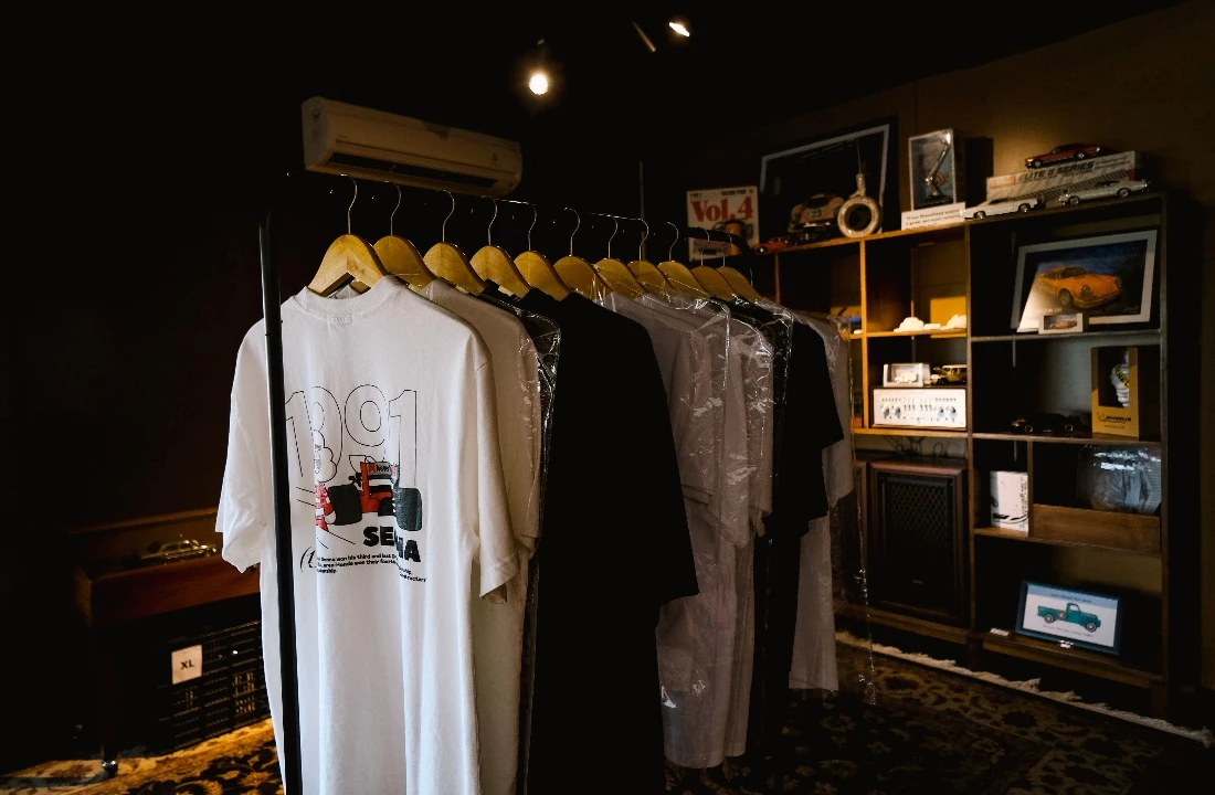 Printed T-shirts hanging in a retail-style showroom, representing product options from a print on demand supplier