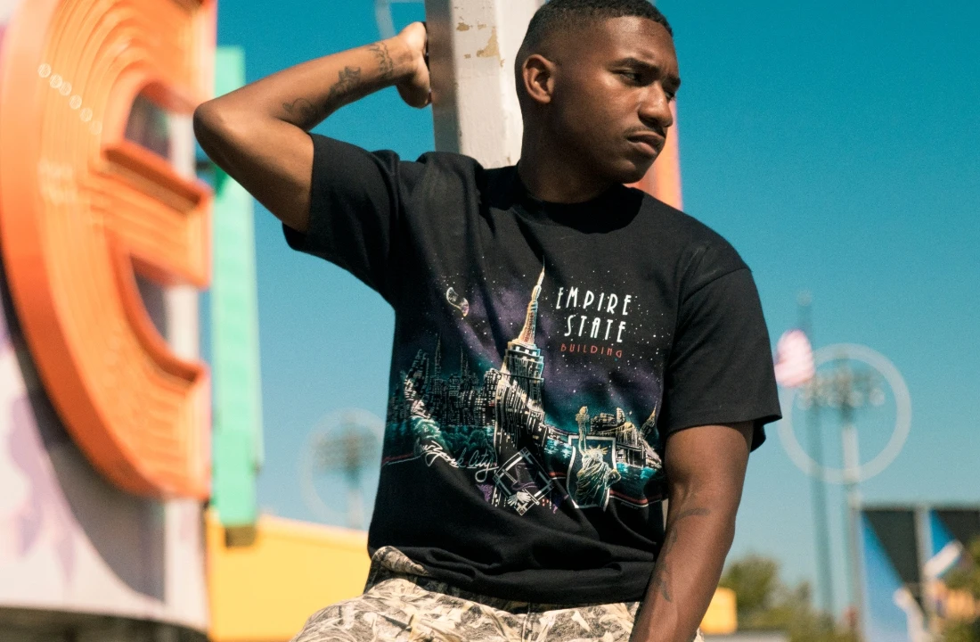 Man wearing a black graphic T-shirt as part of a Print on Demand Streetwear lifestyle look