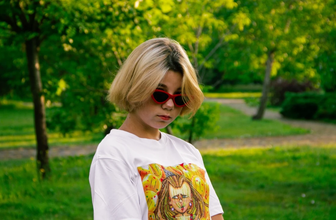 Woman wearing an oversized white T-shirt with a colorful graphic for a DTF vs DTG print comparison
