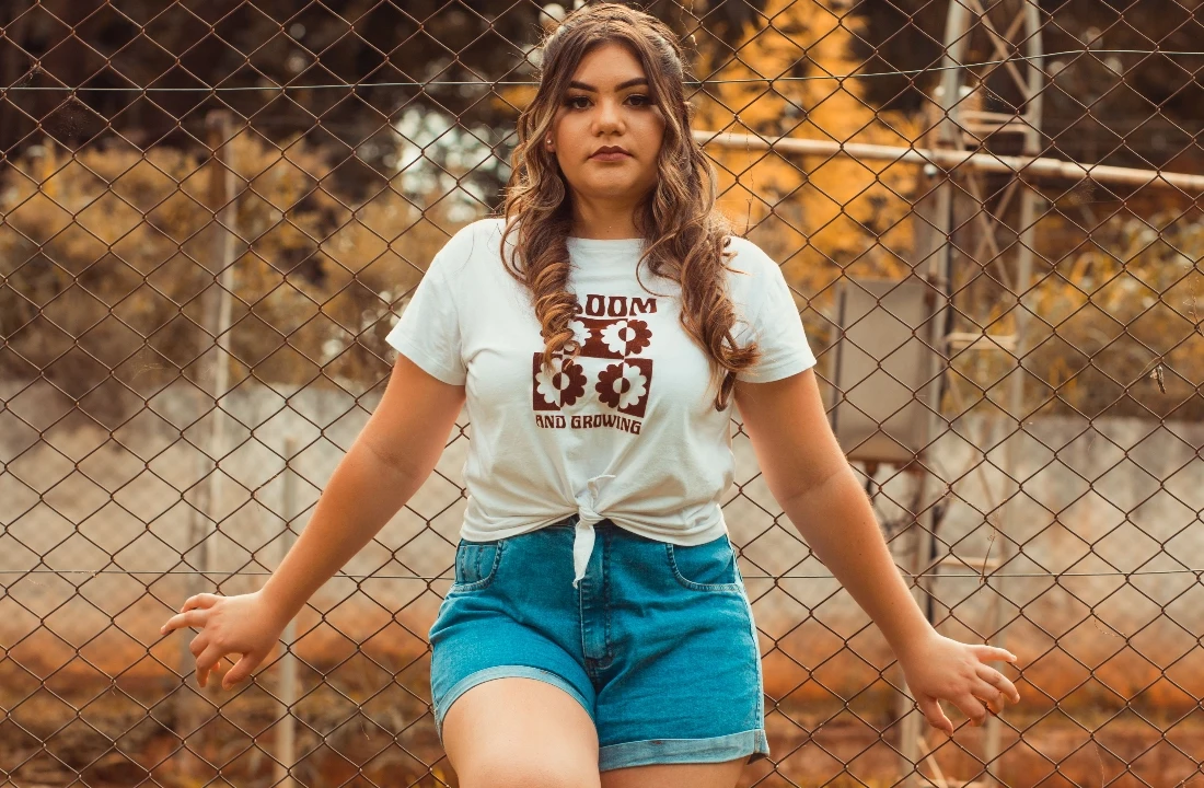 Woman wearing a light-colored graphic T-shirt used to illustrate the DTF vs DTG printing comparison