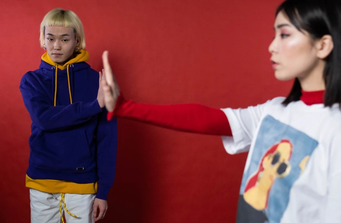 Fashion models wearing a layered hoodie and graphic T-shirt used to illustrate screen printing vs DTF apparel applications