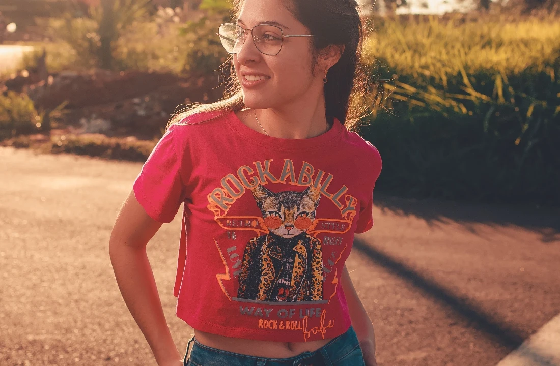 Woman wearing a red cropped T-shirt featuring a large vintage-style cat Jumbo Print graphic