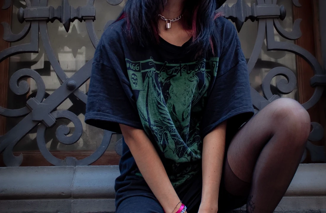Woman wearing a washed black oversized T-shirt with a large green Jumbo Print illustration