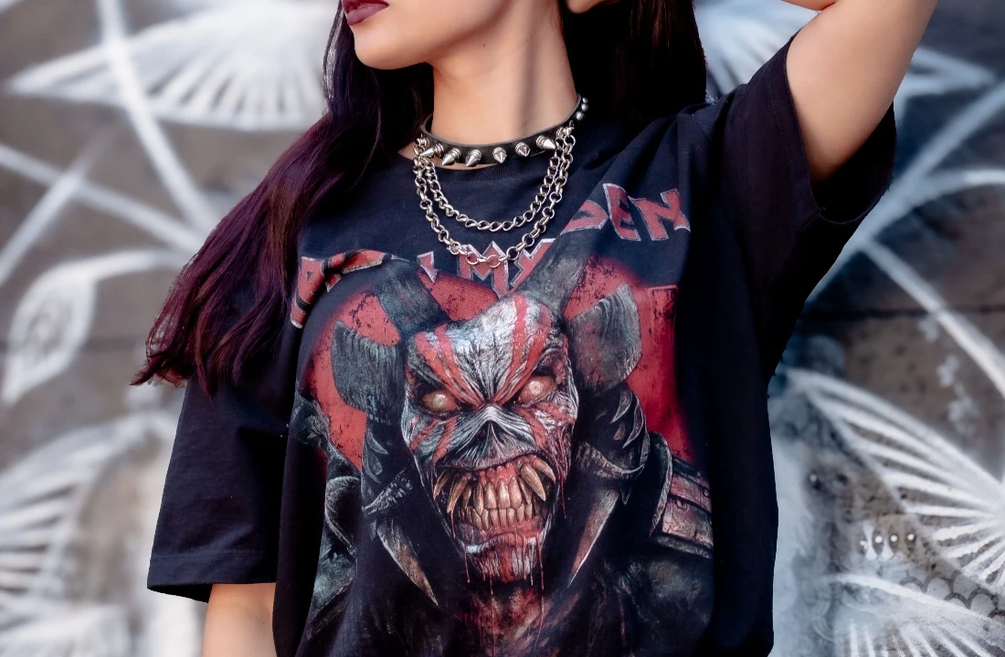 Woman wearing a black streetwear T-shirt featuring a large red and grey Jumbo Print monster design