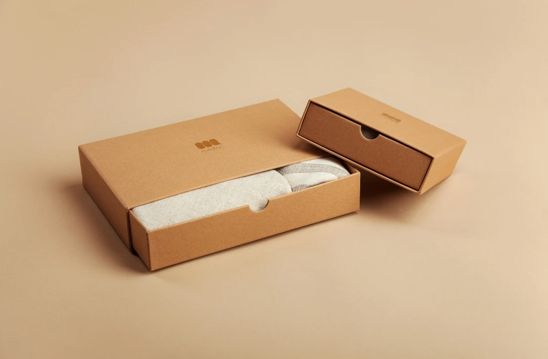 Two kraft drawer boxes designed as premium custom packaging for folded apparel and fashion products