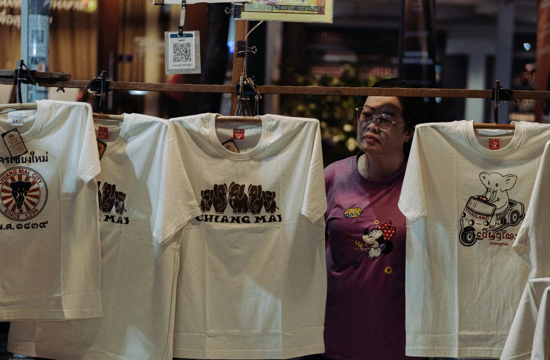 Printed Custom Apparel T-shirts with regional graphic designs displayed at a retail market stall