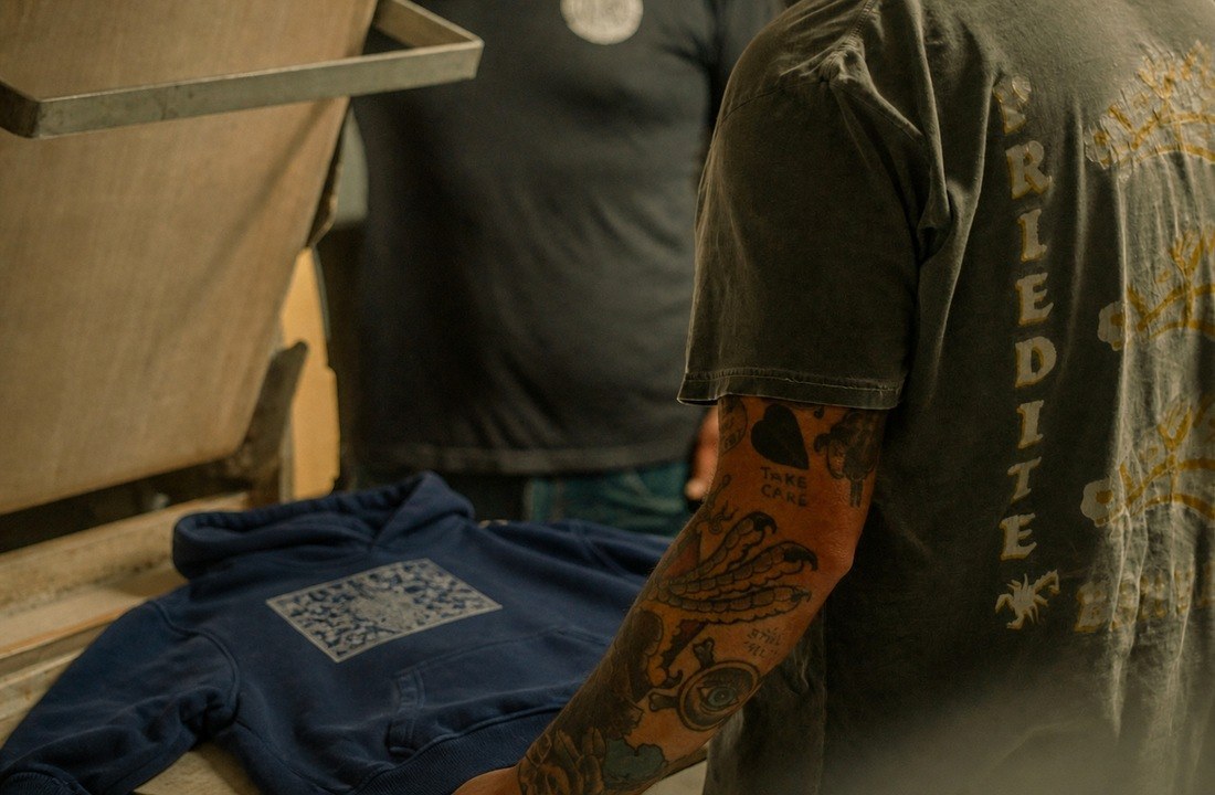 DTF hoodie printing with a heat press in an apparel workshop