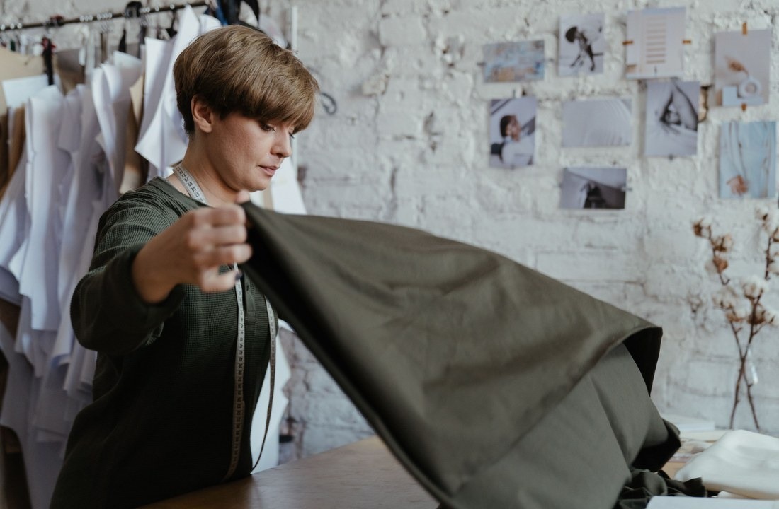Apparel professional evaluating fabric weight for heavyweight hoodies
