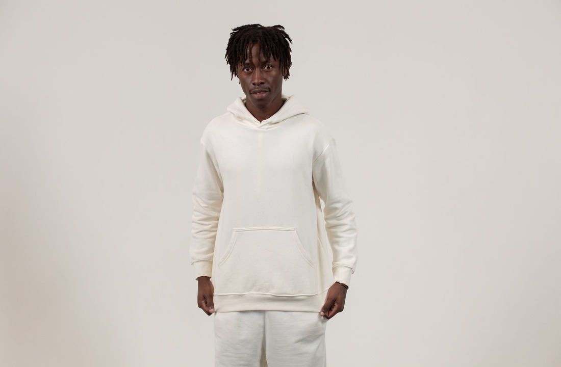 POD brand model wearing a plain hoodie for production route selection