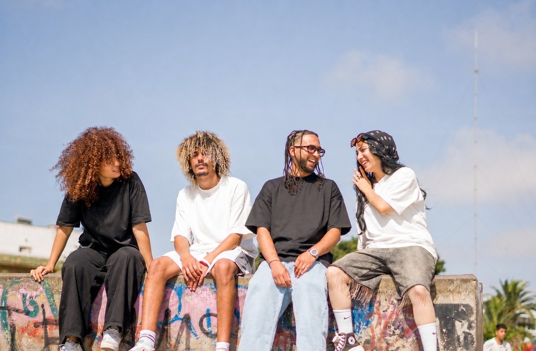 Small batch private label streetwear shown on four adults in unbranded T-shirts