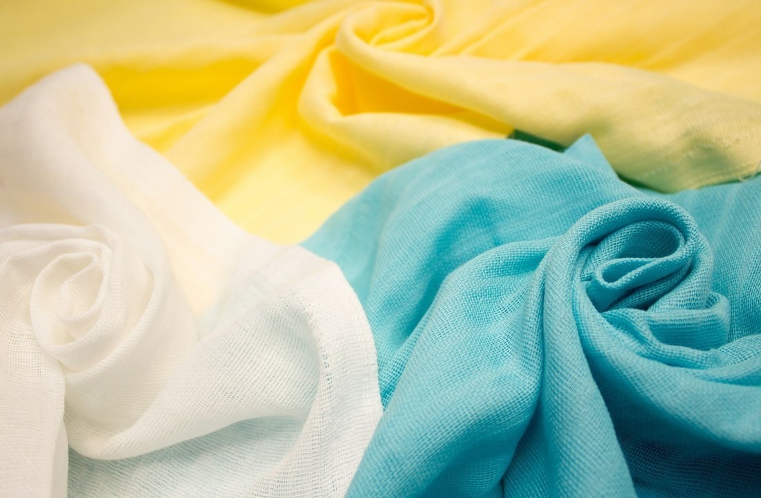 Fabric rolls representing material inputs in custom apparel pricing
