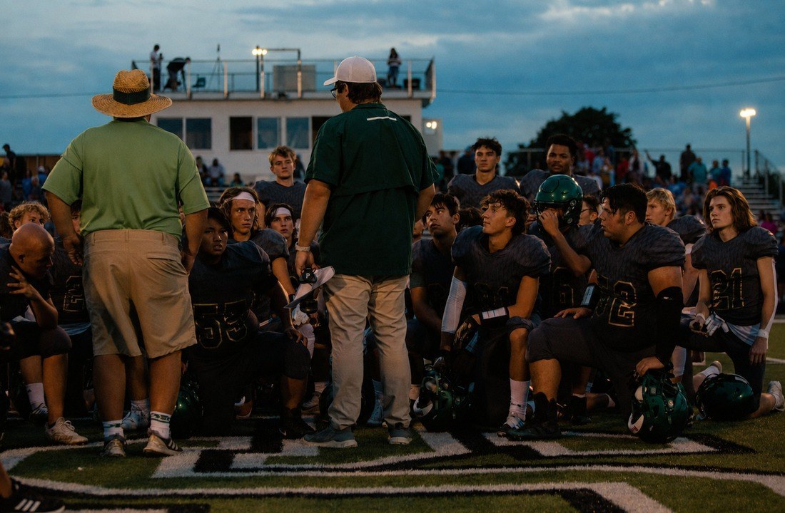 Football team meeting before a game in coordinated uniforms