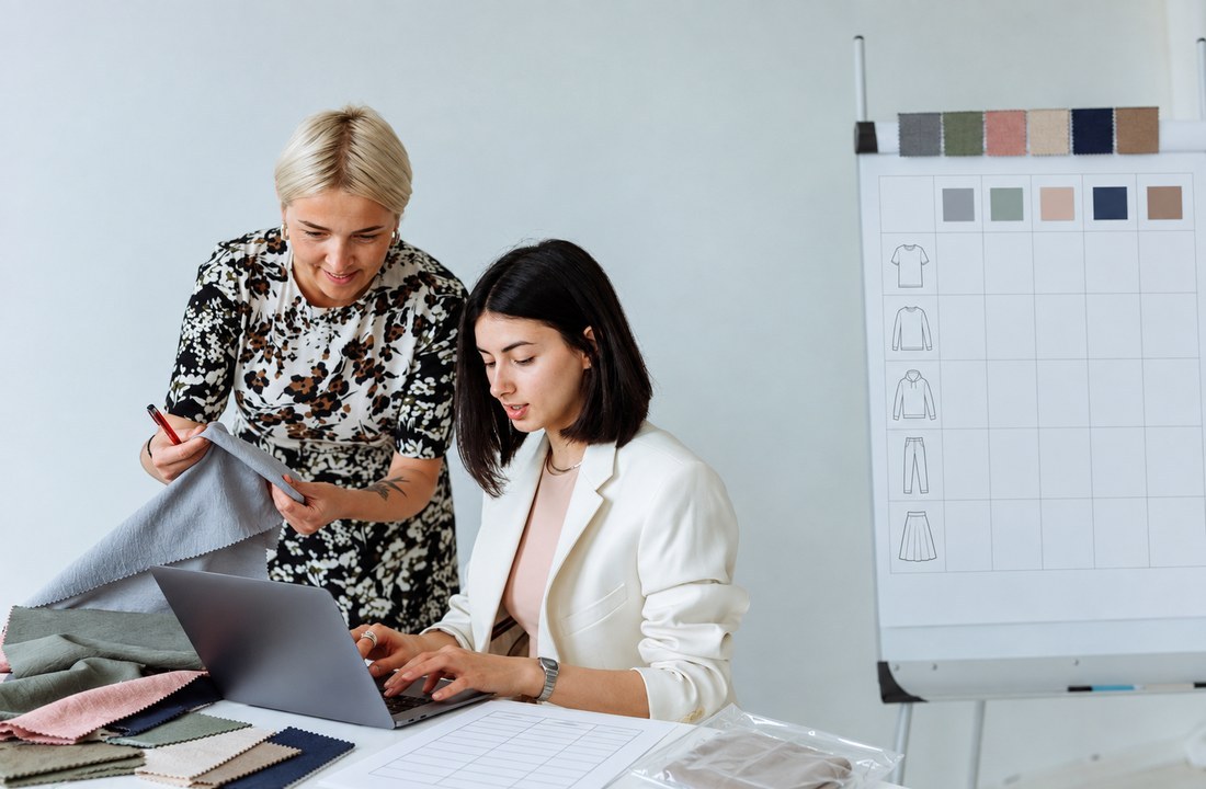Apparel sourcing team comparing fabric swatches and a blank specification grid