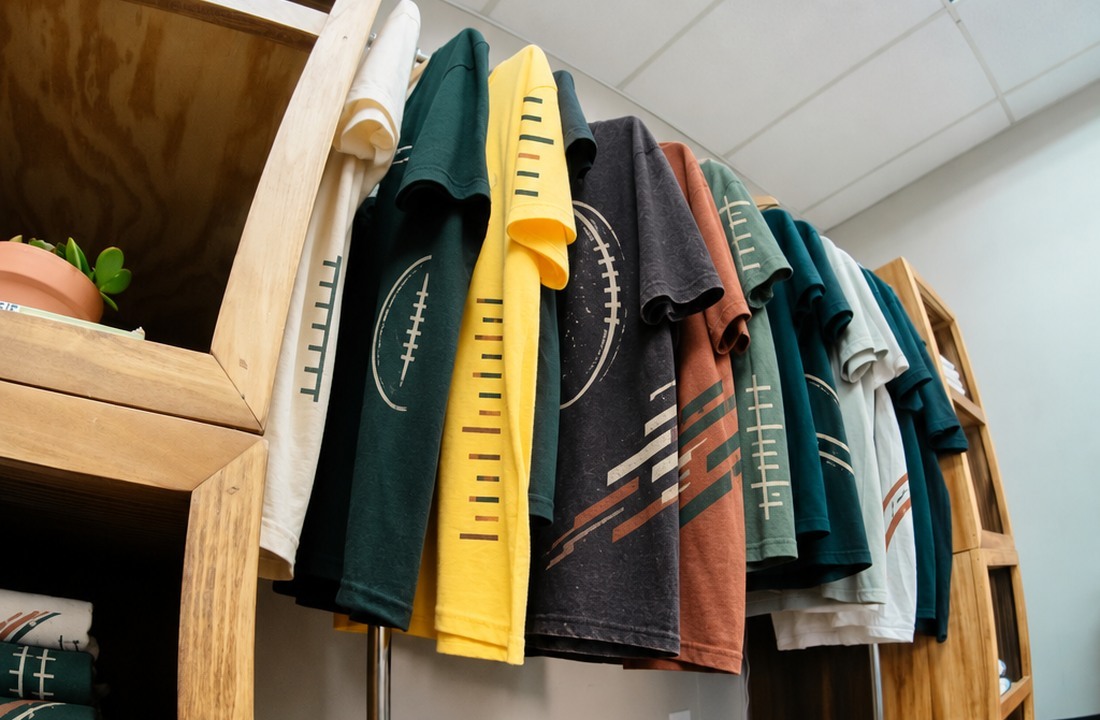 Small batch T-shirt samples reviewed before an inventory reorder