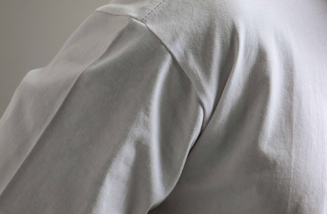 Plain white T-shirt shoulder and fabric texture