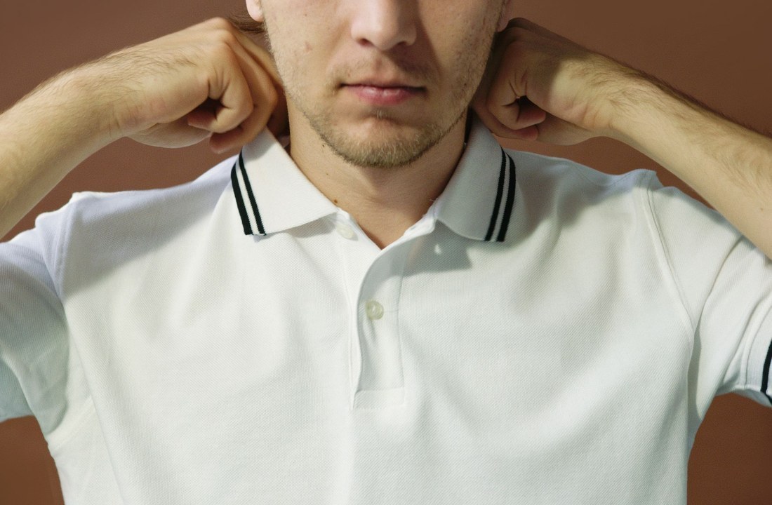White polo shirt collar and sleeve trim shown close up