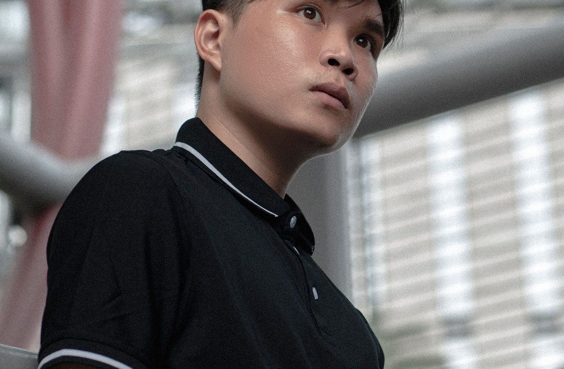 Black polo shirt fit and collar seen on a model