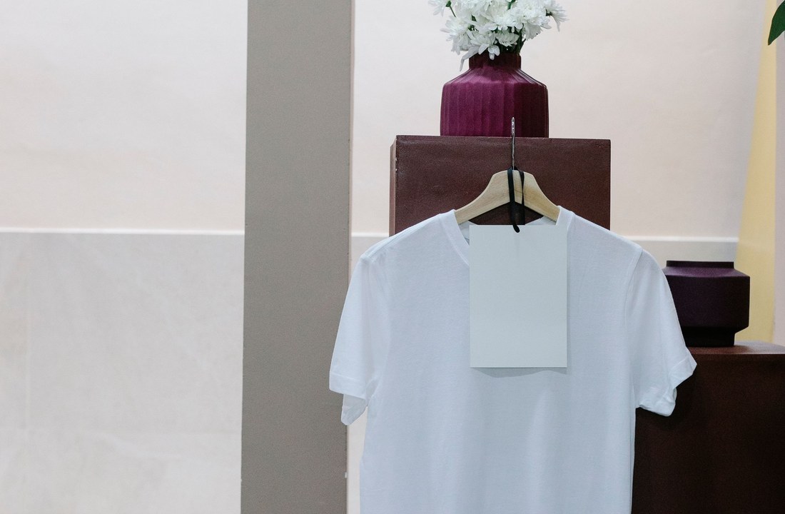Plain white T-shirt hanging with a blank tag