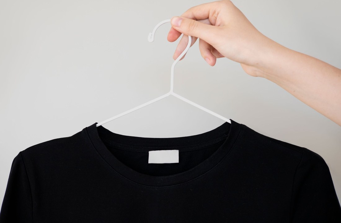 Plain black crew-neck T-shirt hanging alone