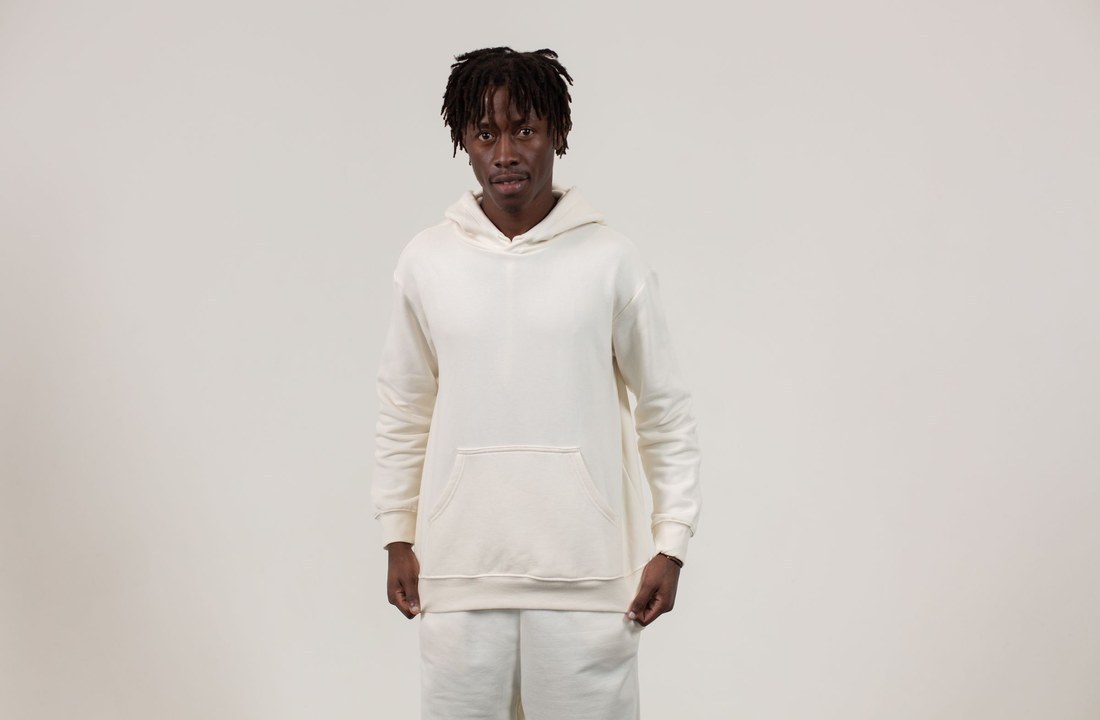 Model wearing a plain white pullover hoodie