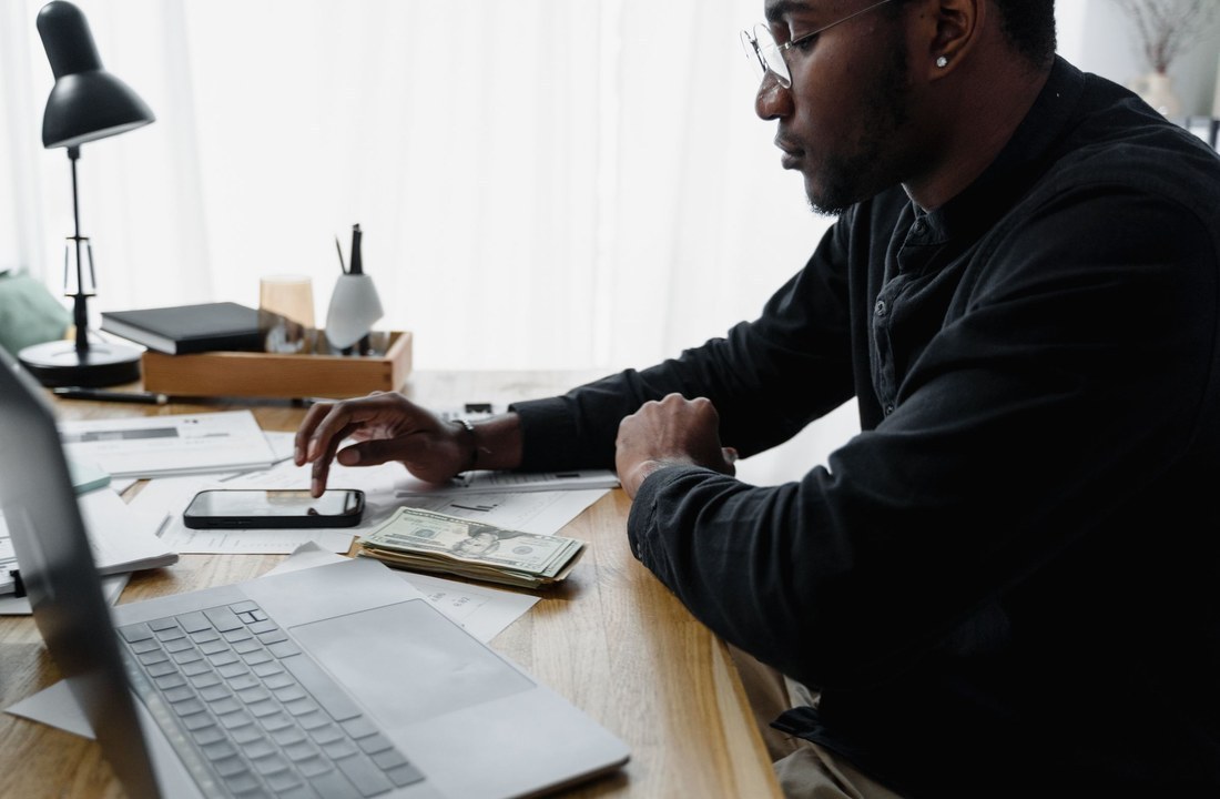 Buyer reviewing paperwork and cash at a desk