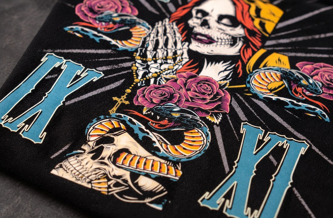 Close-up of colorful DTF artwork and fine print edges on black T-shirt fabric